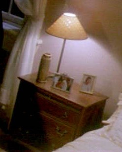 the bedside table on the left side of the bed