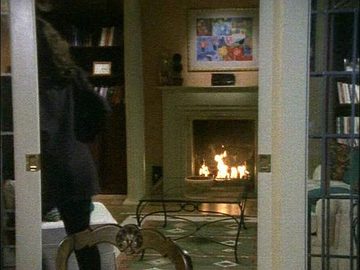 angle towards the fireplace through the doors from the dining room, showing the coffee table