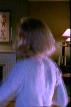 Beyond the fireplace, in the corner of the living room, is a computer table.