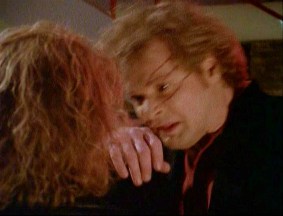 Divia slashes Nick's face with her fingernails.