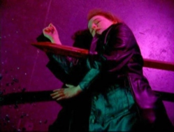 staked through the heart, Divia lies on the floor of the Raven