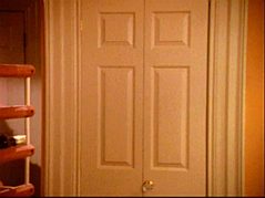 the double-doored cupboard just inside the kitchen